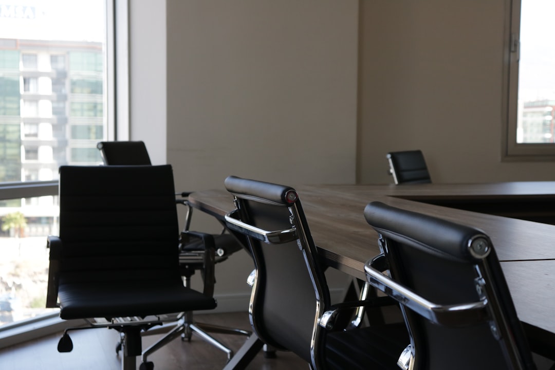Daylight in a meeting room with a wooden table and leather chairs
