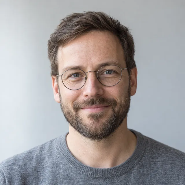 Jonas Weller, in round glasses and a gray sweater