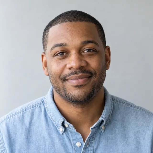 Tobias Kline, smiling, in a light blue denim shirt